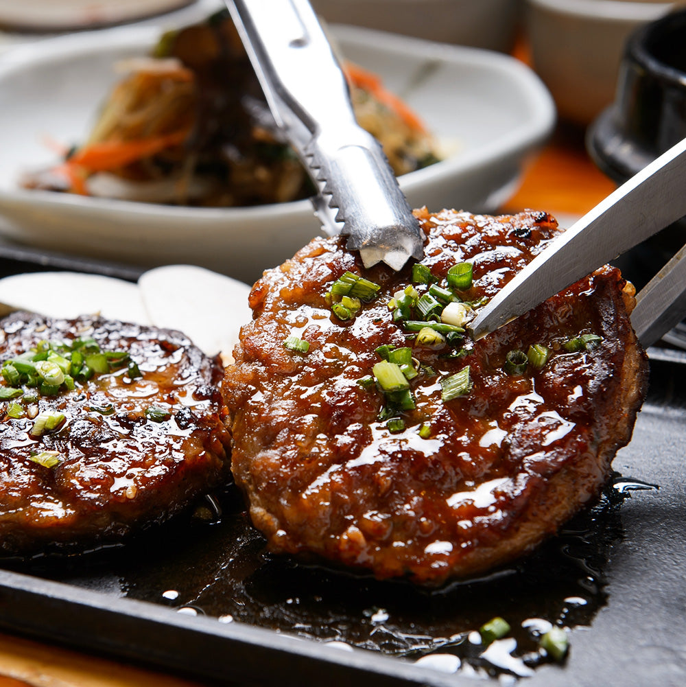 Close-up view of Songjeong tteokgalbi (Korean grilled short rib patties, Jeolla regional specialty) – 4 servings | Banchan365