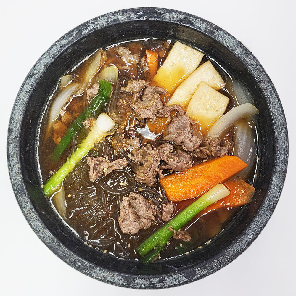 Ttukbaegi-bulgogi (Korean sizzling beef bulgogi in stone pot) served and plated | Banchan365