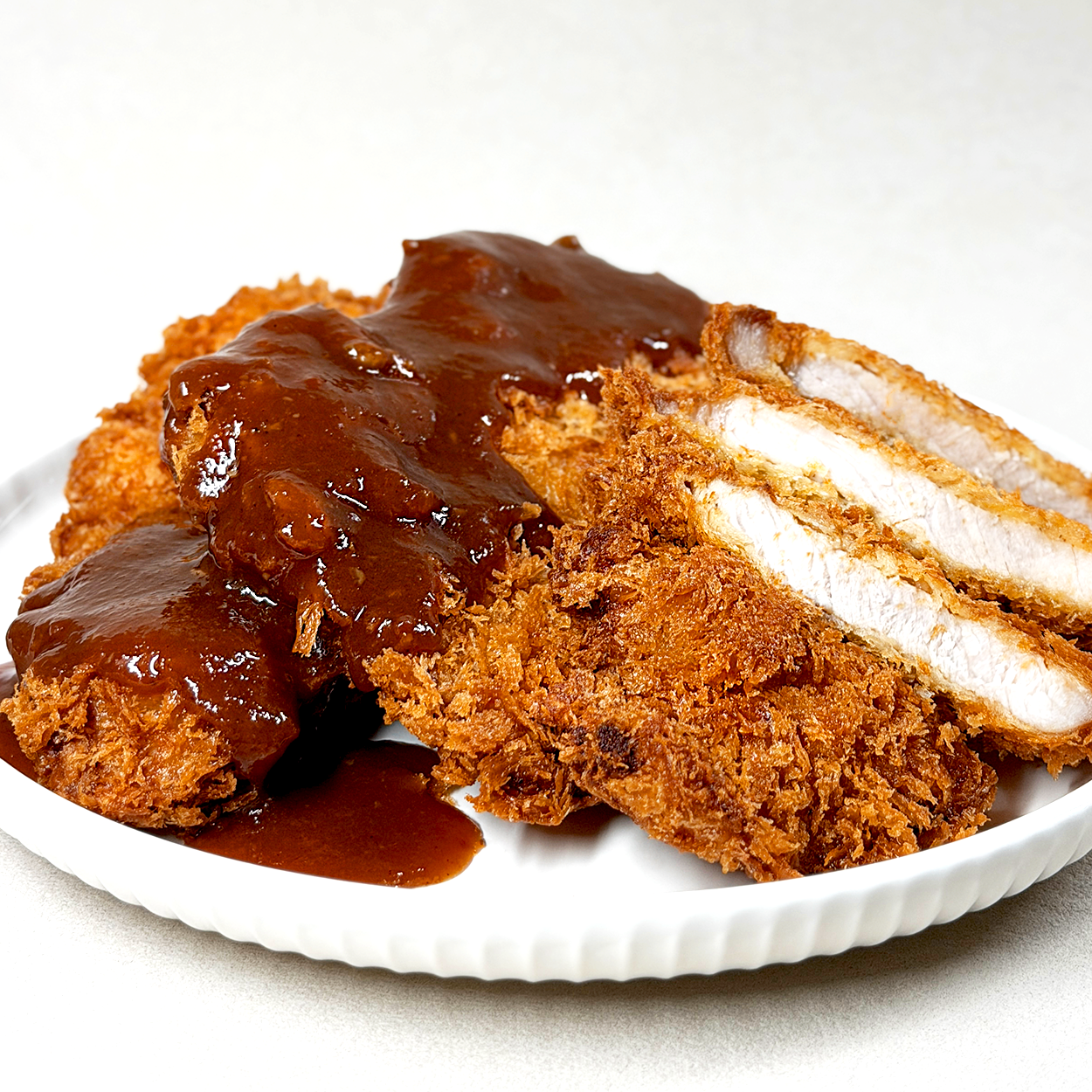 Tonkatsu (Korean-style thick pork cutlet) – housemade with sauce served and plated | Banchan365