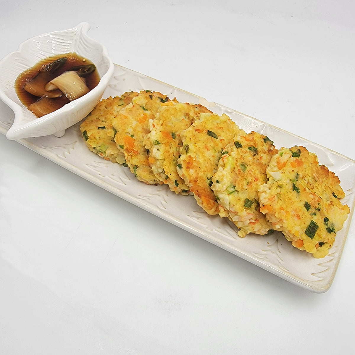Gemassal saeu yachae-jeon (Korean crab stick shrimp vegetable pancake) served and plated | Banchan365