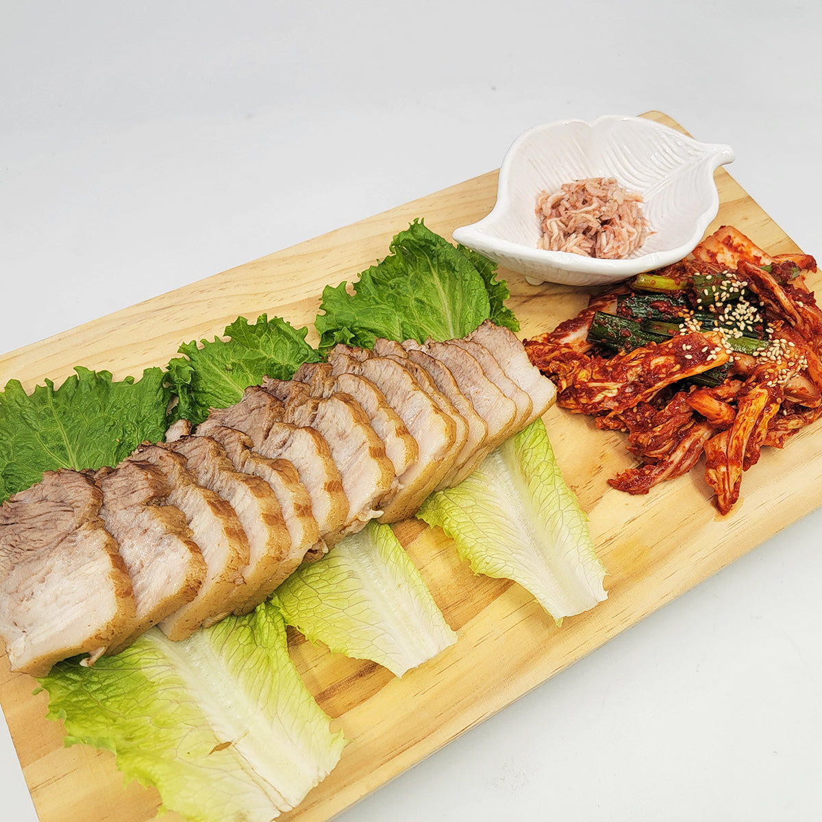 Bossam (Korean steamed pork belly wrap set) served and plated | Banchan365