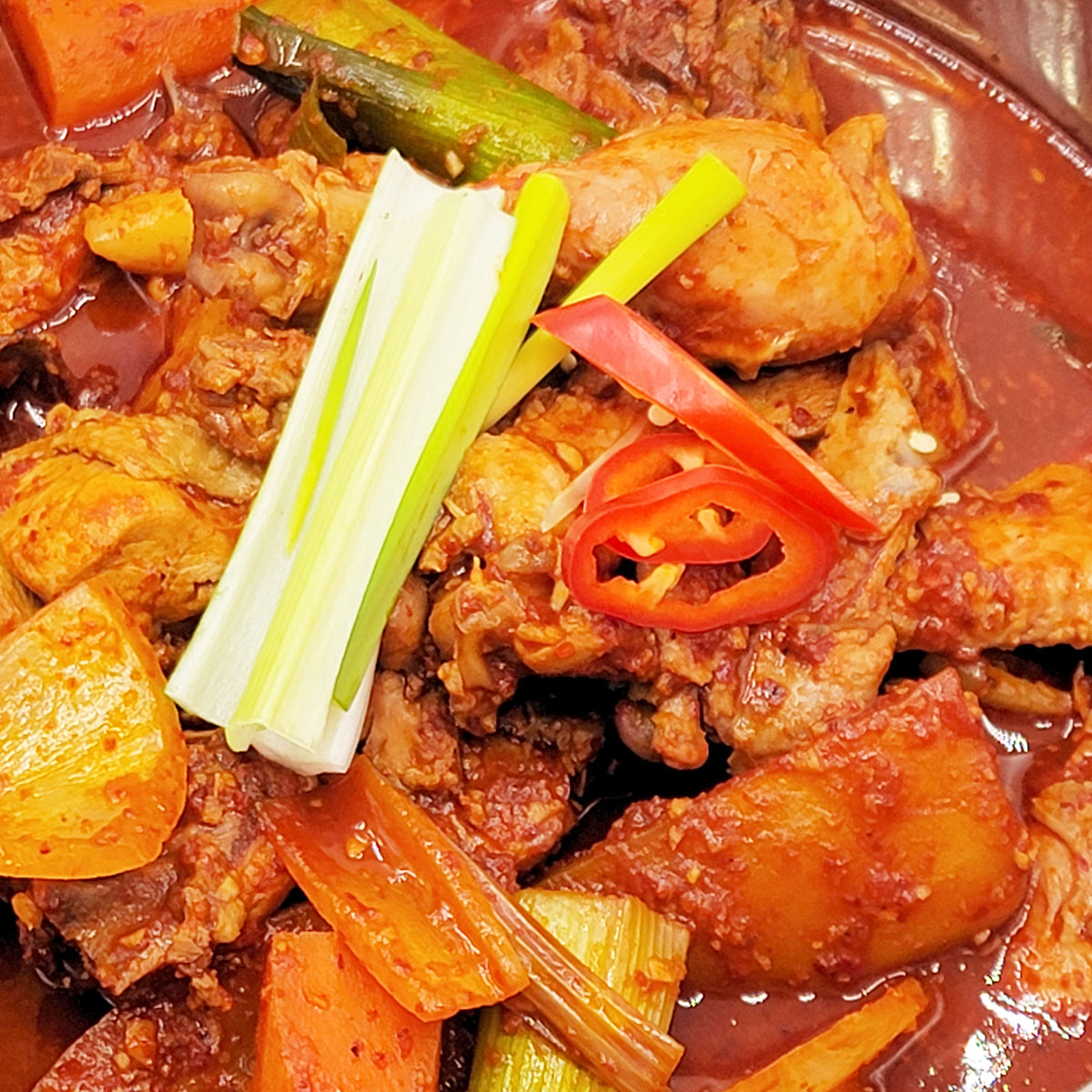 Close-up view of Dakbokkeumtang (Korean spicy braised chicken stew) | Banchan365