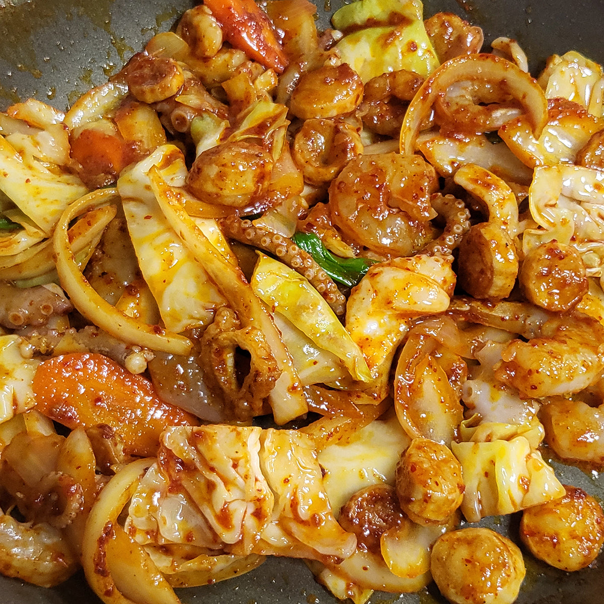 Close-up view of Nakji daechang saeu-bokkeum (Korean stir-fried octopus, intestine, and shrimp) | Banchan365