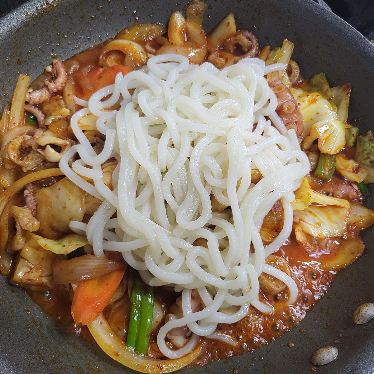Nakji daechang saeu-bokkeum (Korean stir-fried octopus, intestine, and shrimp) served and plated | Banchan365