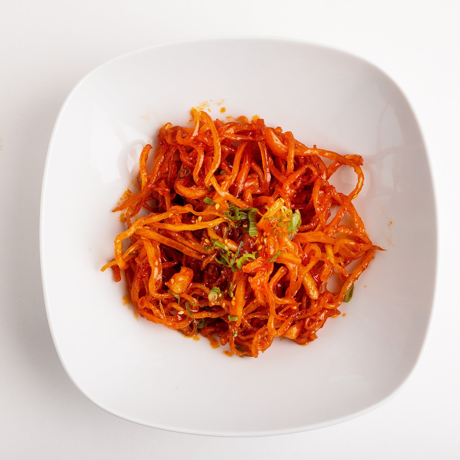 Gochujang jinmichae (Korean spicy dried squid strips) – large size served and plated | Banchan365