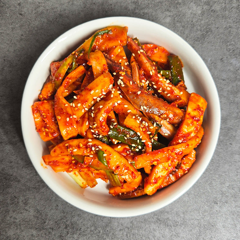 Close-up view of Ojingeo chomuchim (Korean spicy vinegared squid salad) | Banchan365