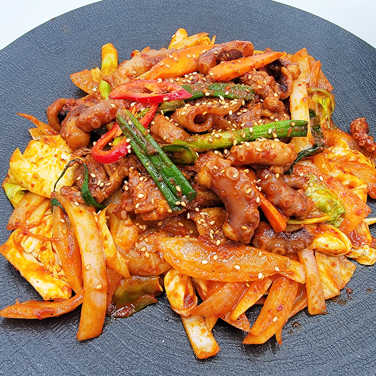 Close-up view of Nakji samgyeopsal (Korean octopus and pork belly stir-fry) – 1.5 lb | Banchan365